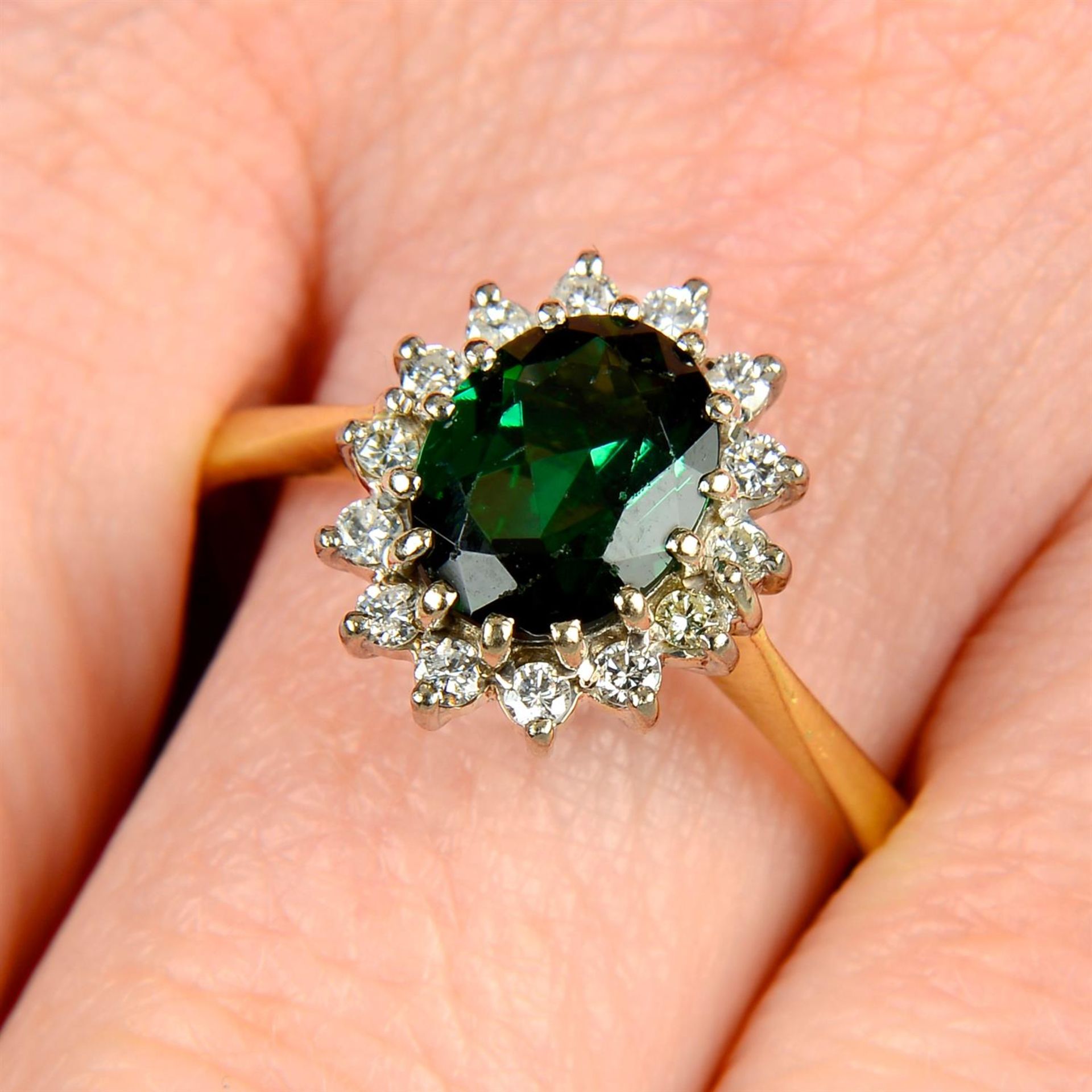 An 18ct gold green tourmaline and brilliant-cut diamond cluster ring.