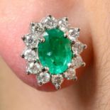 A pair of emerald and diamond cluster earrings.