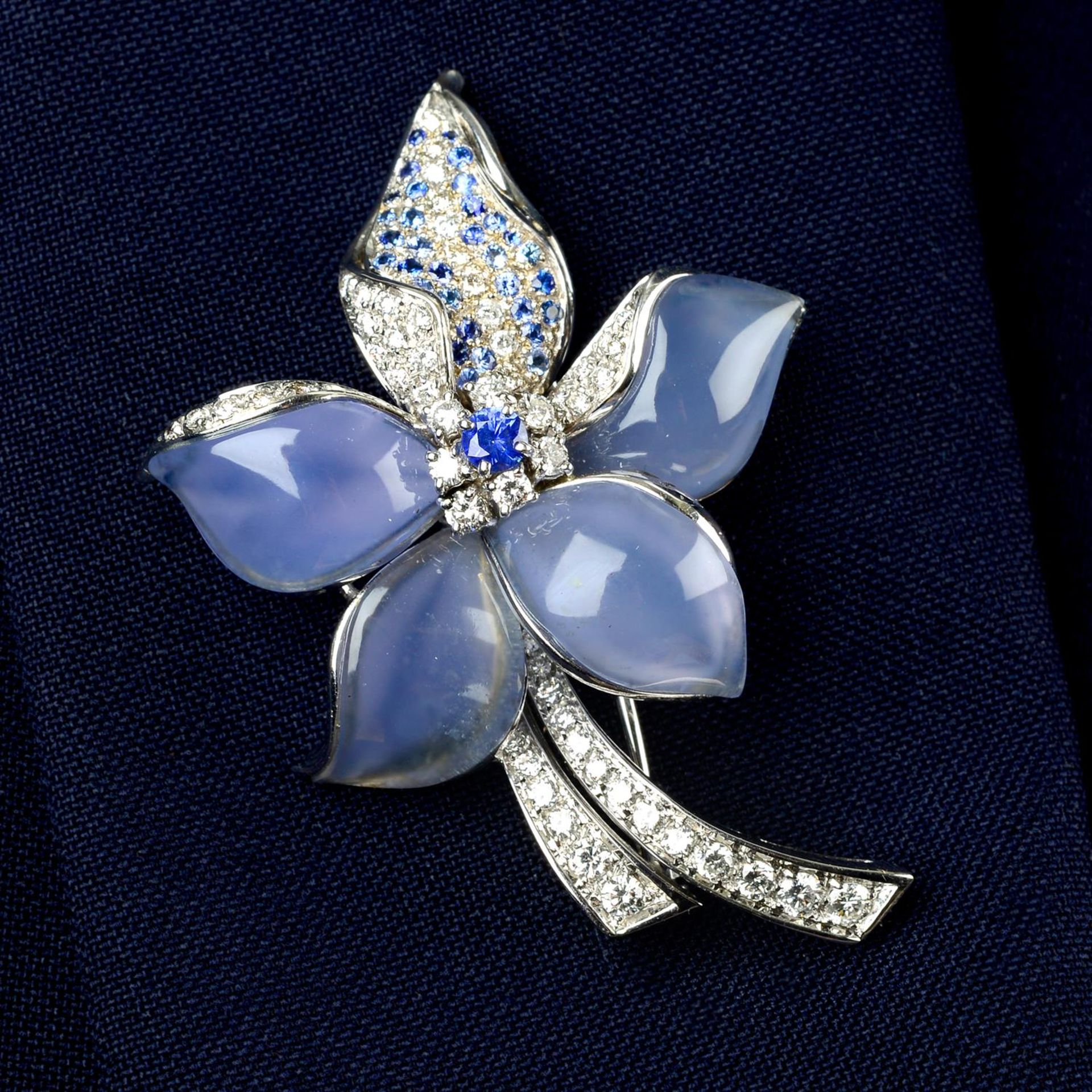 A dyed blue chalcedony, sapphire and diamond floral brooch.