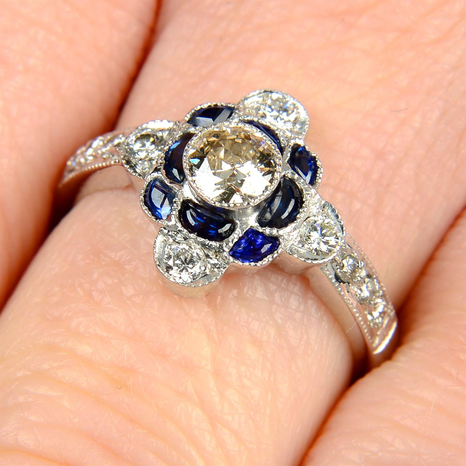 A brilliant-cut diamond and sapphire dress ring.