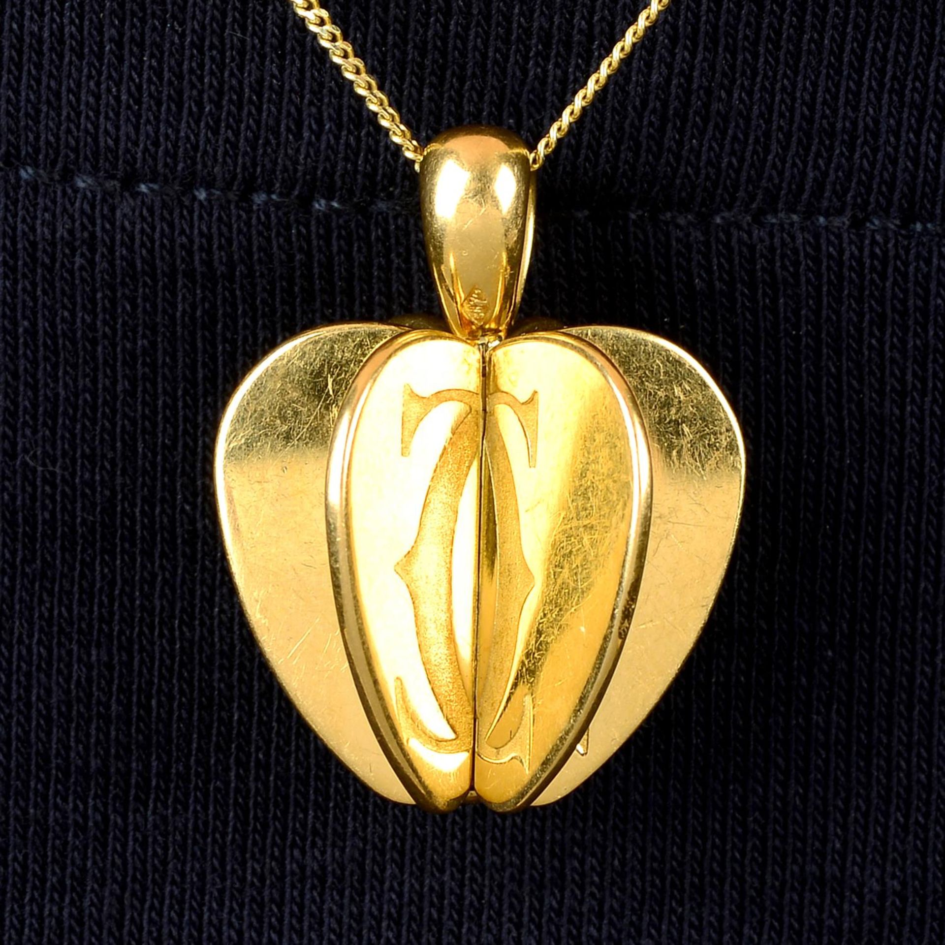 An Apple pendant, by Cartier.
