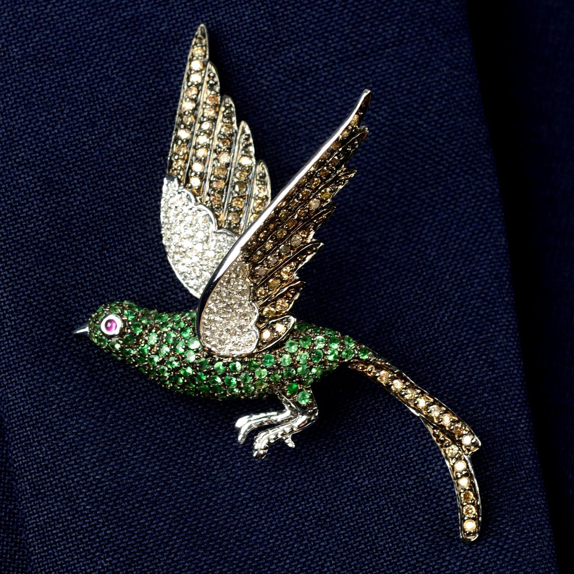 A 'brown' diamond, diamond and green garnet bird brooch, with ruby eye.