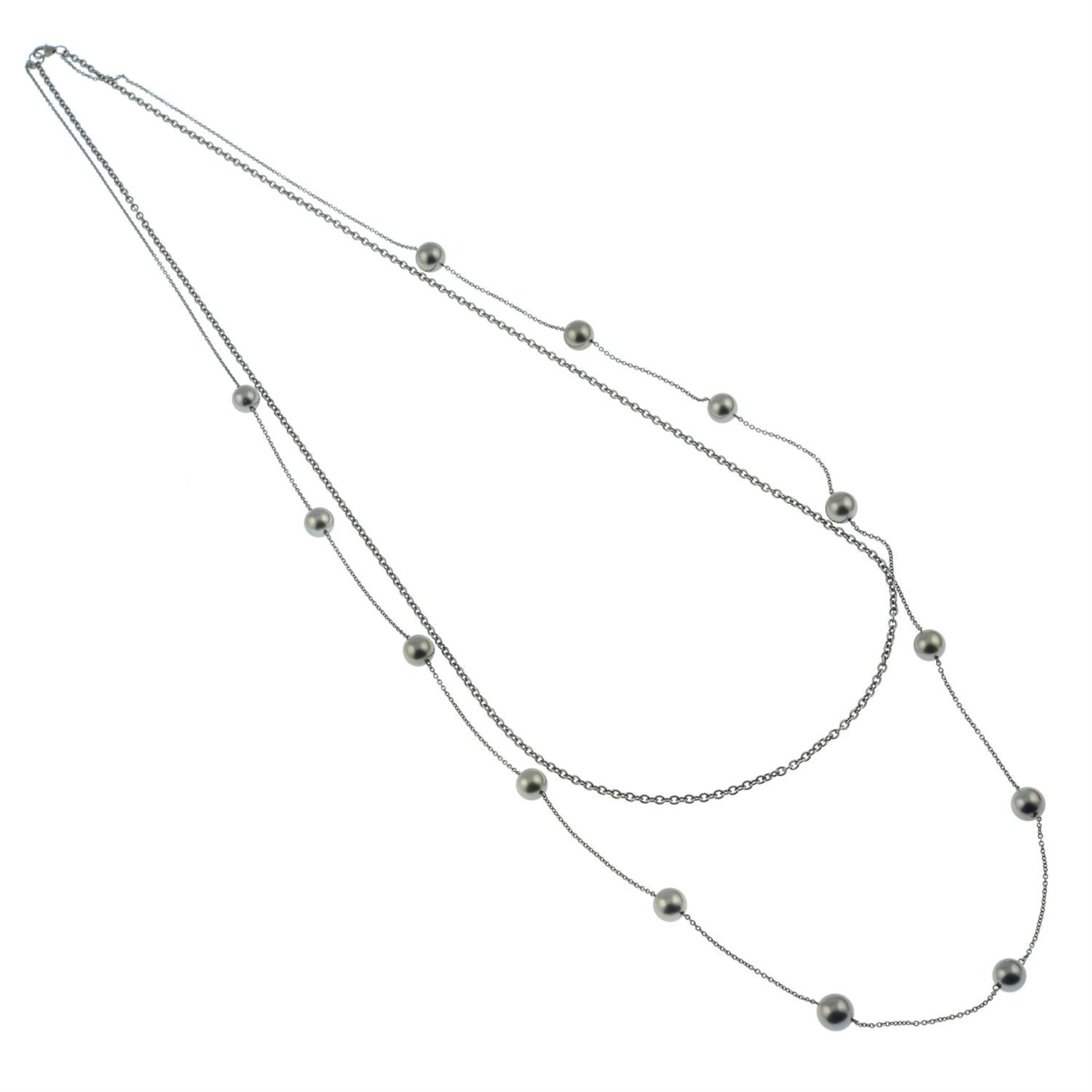 An 18ct gold 'Tahitian' cultured pearl station and plain trace-link two-strand necklace, - Image 3 of 5