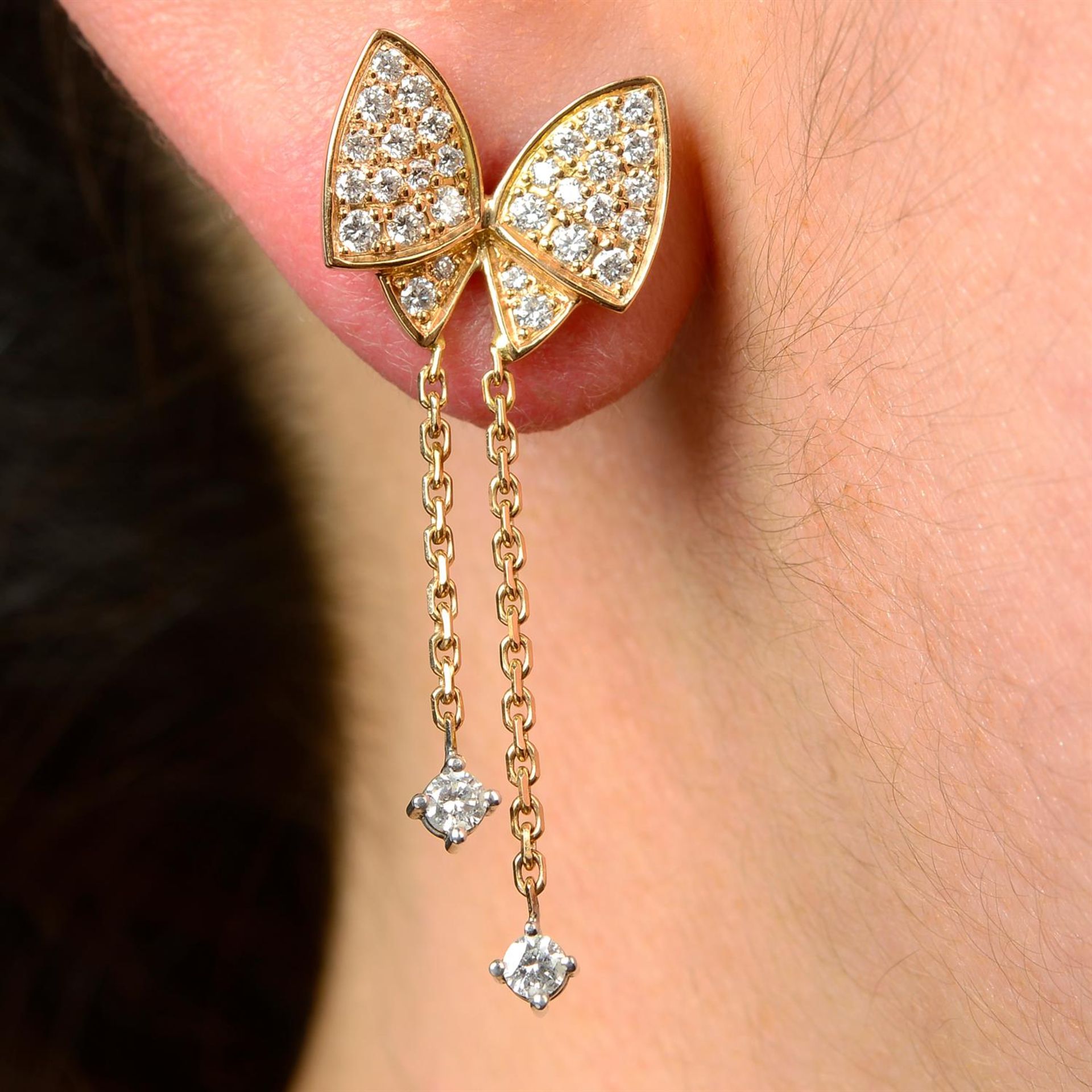 A pair of 18ct gold diamond earrings, designed as butterflies.