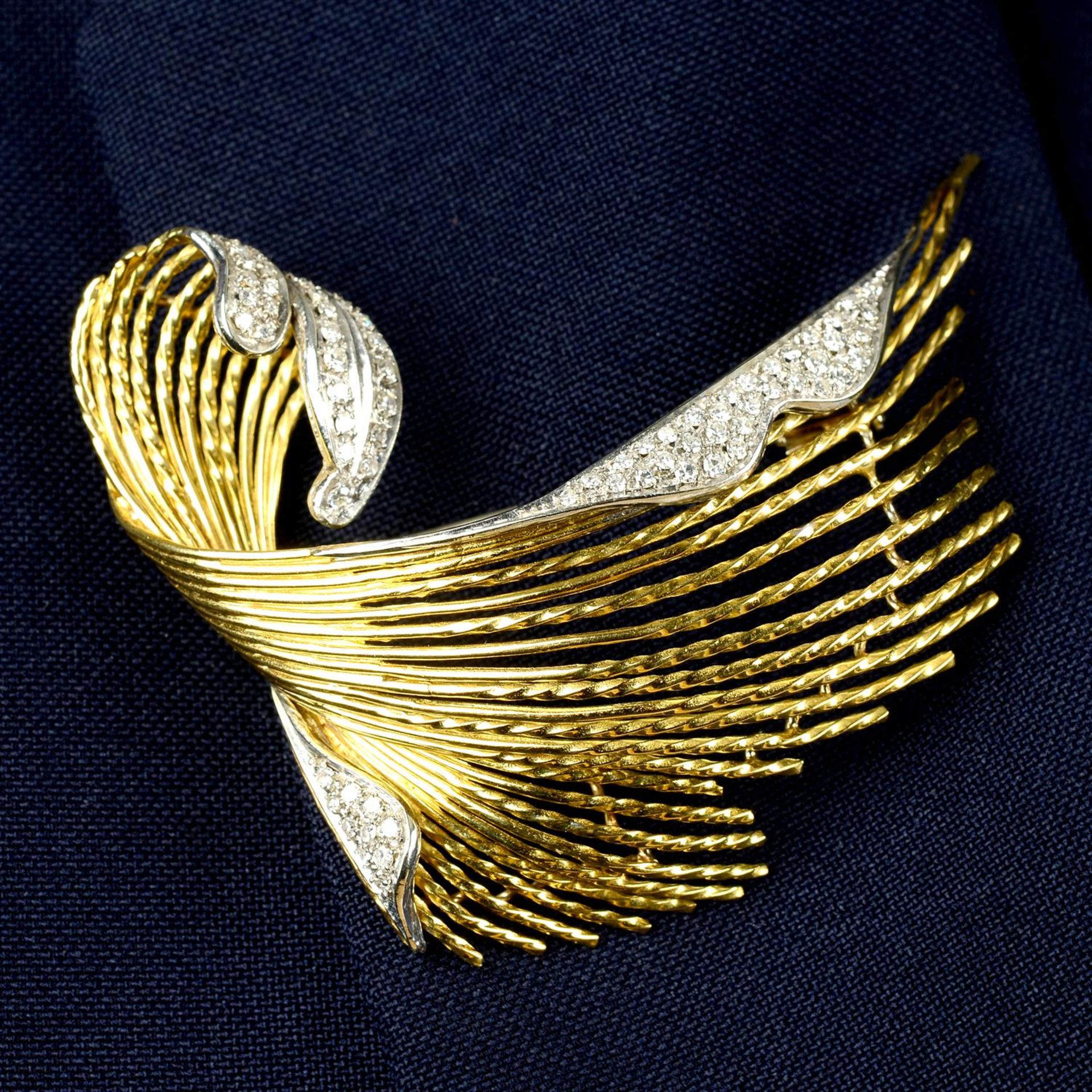 A mid 20th century 18ct gold pavé-set diamond scroll brooch.