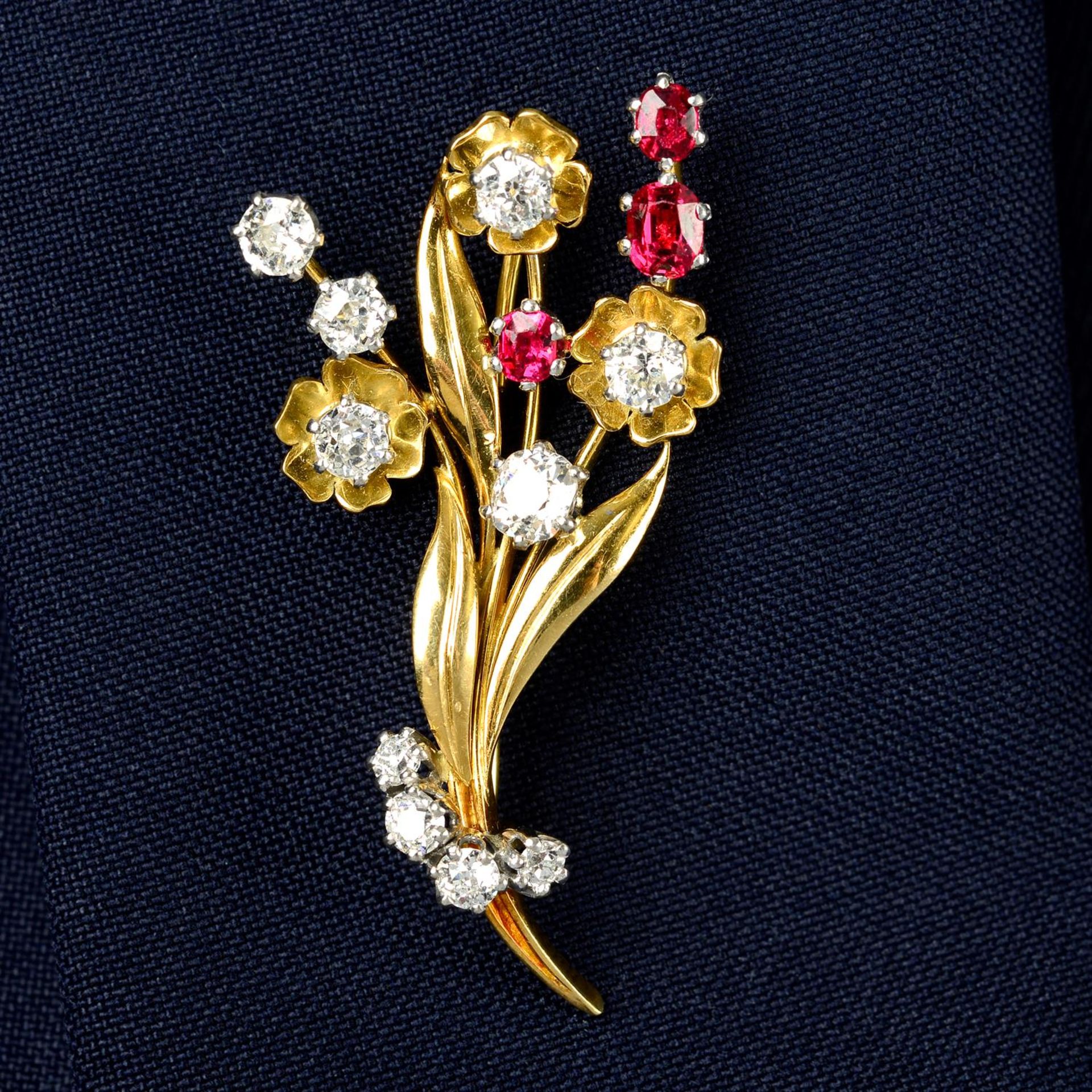 A mid 20th century 18ct gold old-cut diamond and red spinel floral brooch.