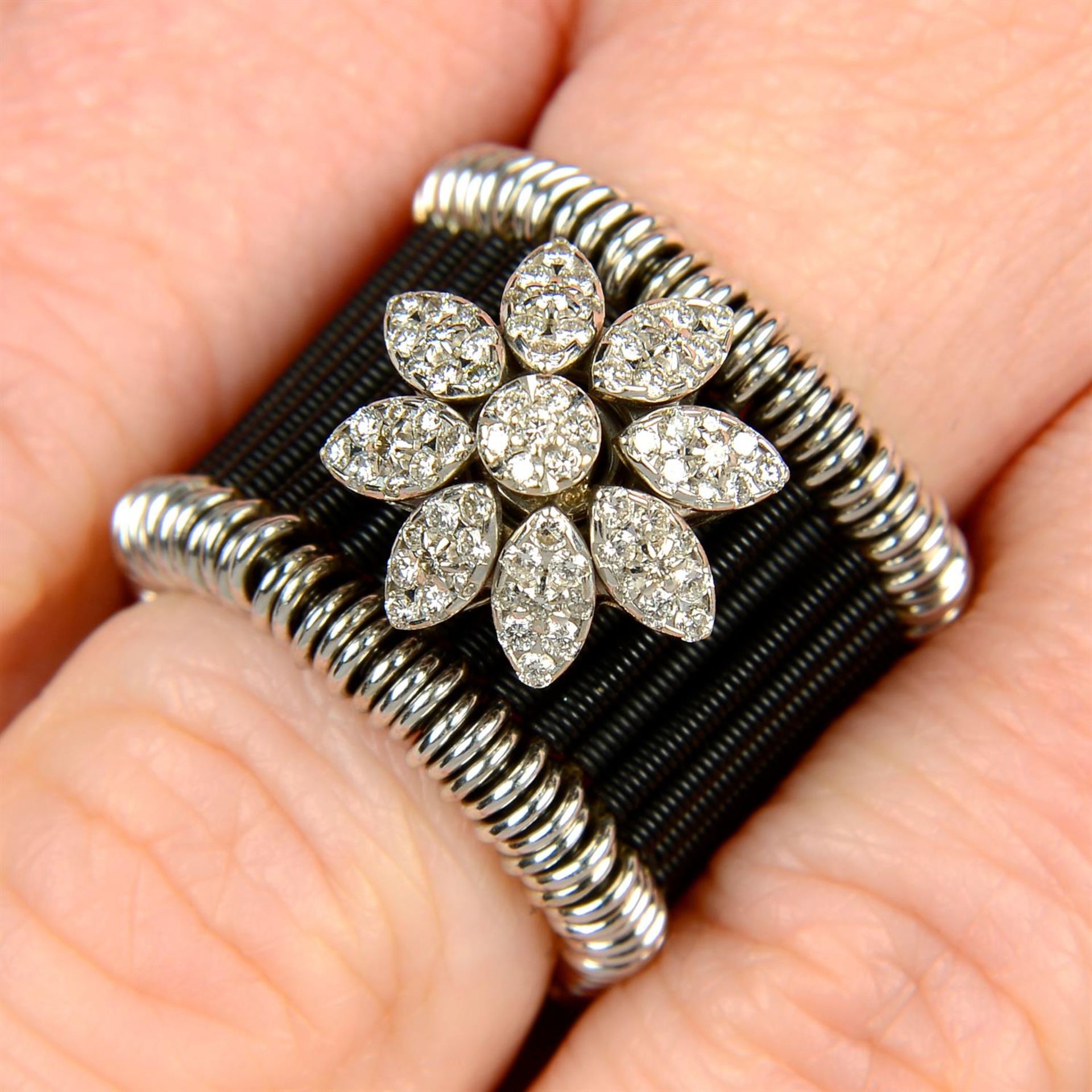 An 18ct gold and black stainless steel 'Shanghai Flower' ring, with brilliant-cut diamond spinning