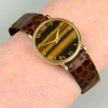 A 1970s 18ct gold watch, with tiger's-eye dial and textured bezel, by Piaget.