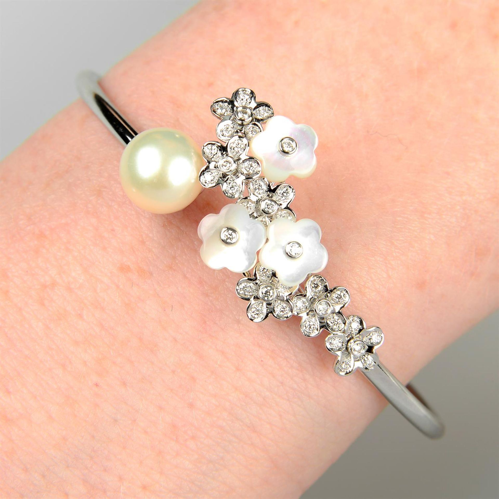 An 18ct gold diamond, mother-of-pearl and cultured pearl floral cuff bangle.