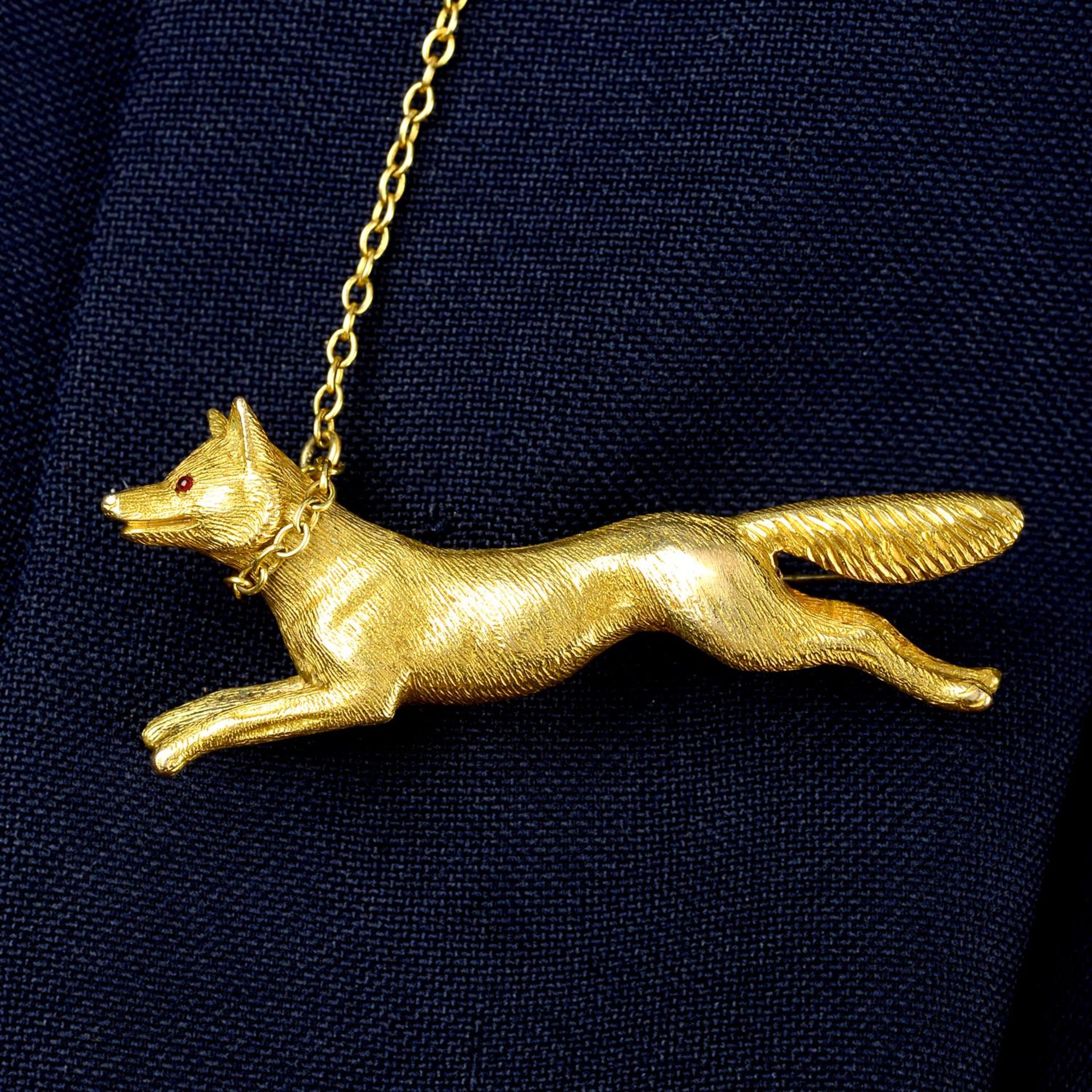 An early 20th century gold textured fox brooch, with garnet eyes.