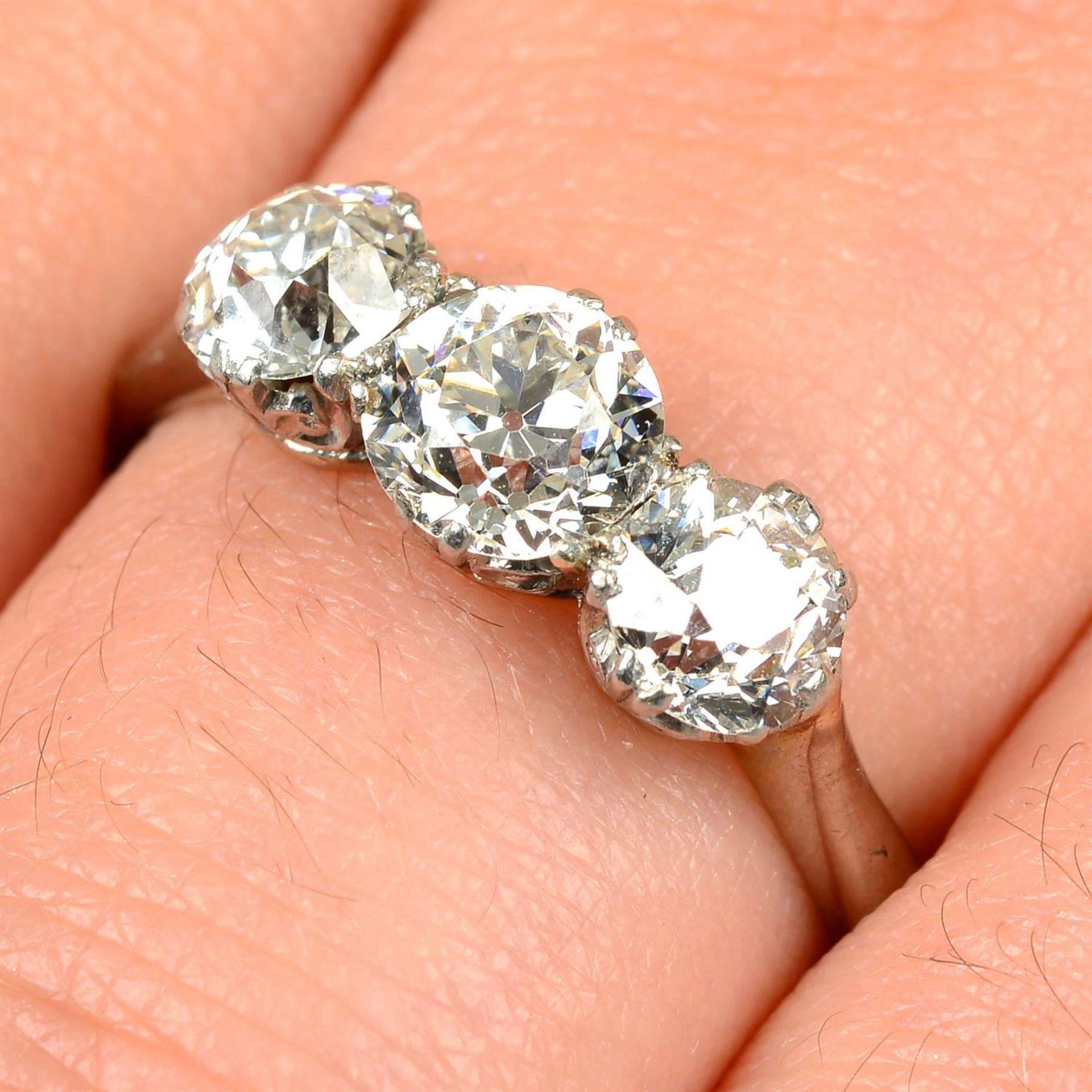A graduated circular-cut diamond three-stone ring.