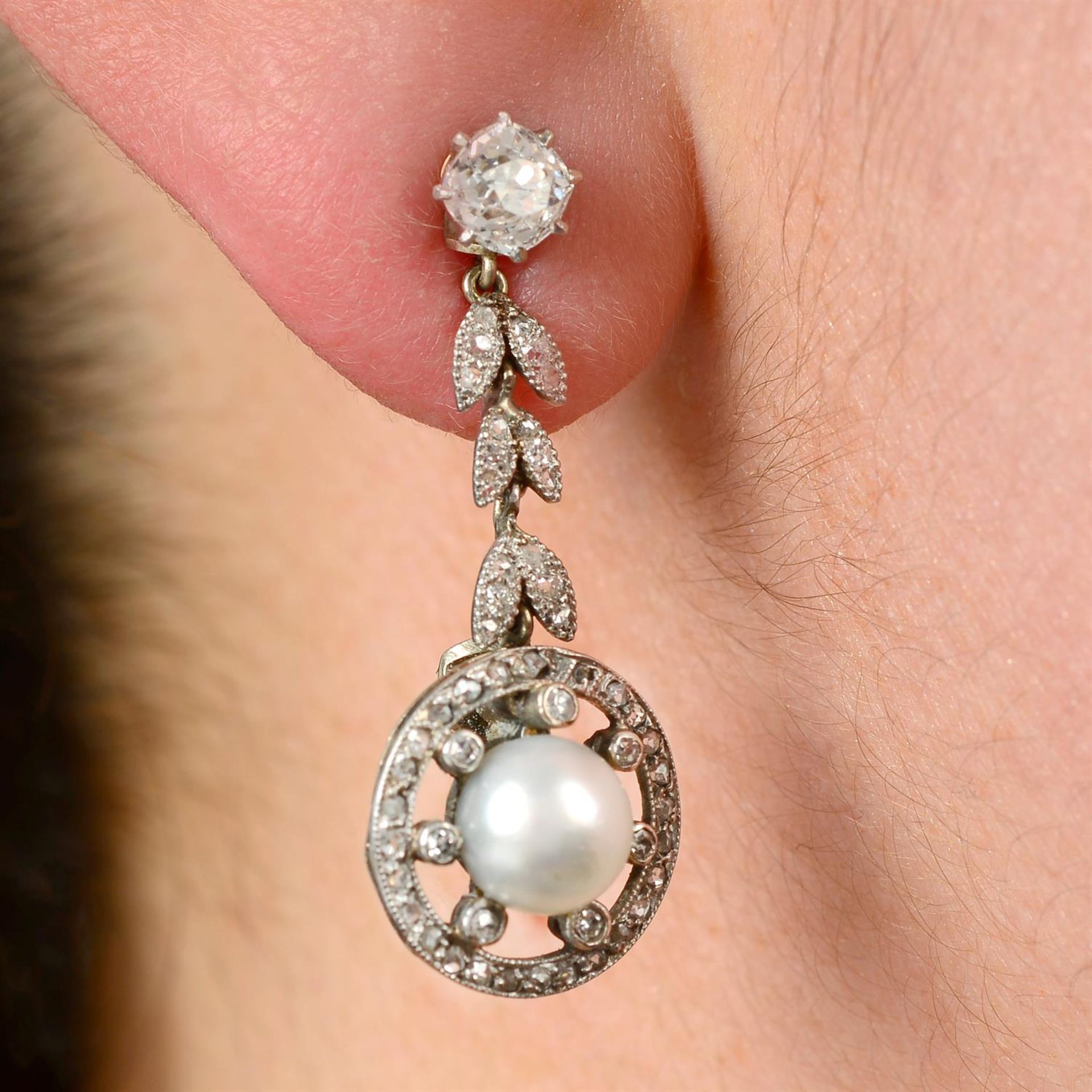 A pair of old-cut diamond stud earrings, with detachable natural pearl and diamond foliate drop.