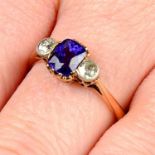 An early 20th century 12ct gold purple Sri Lankan sapphire and circular-cut diamond three-stone