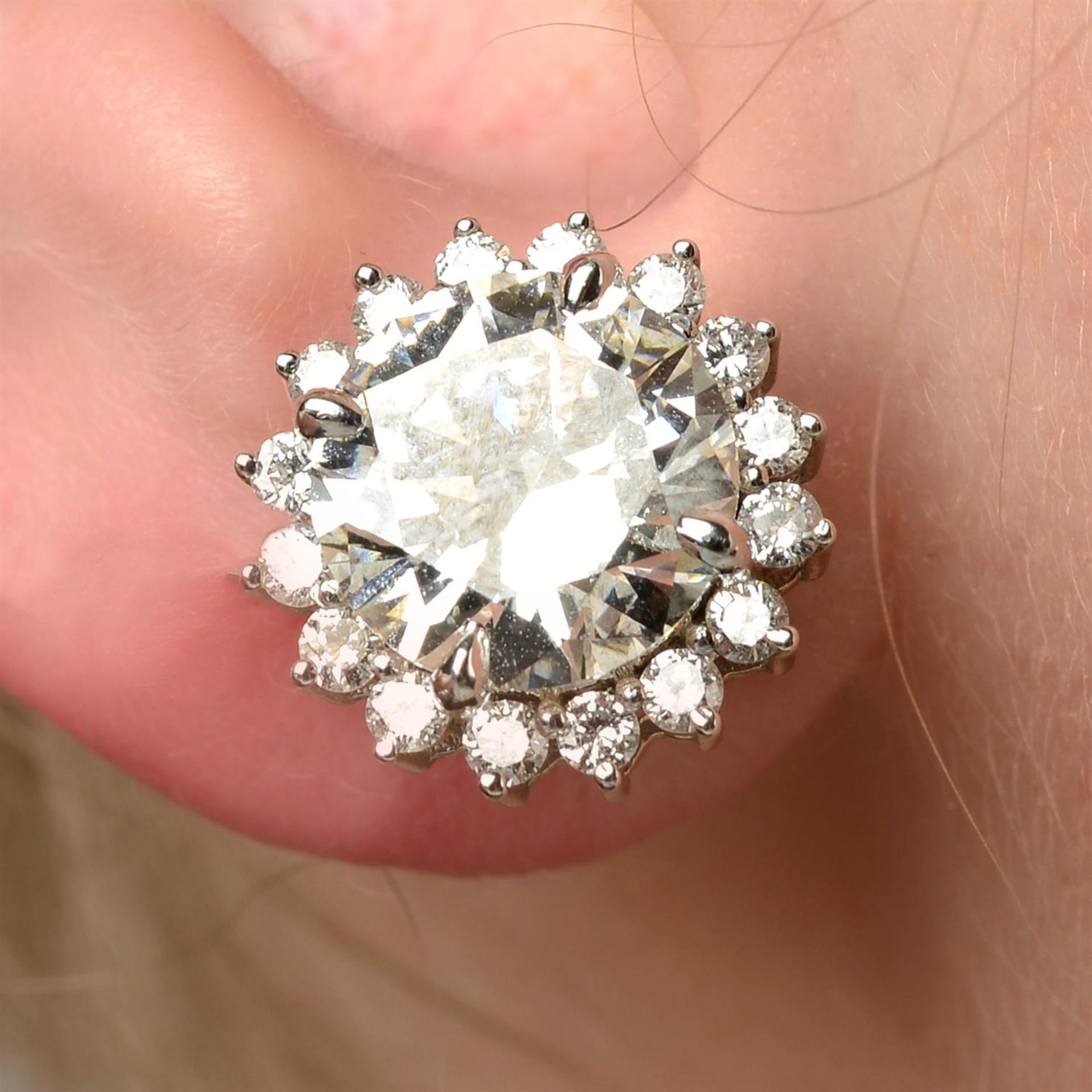 A pair of brilliant-cut diamond cluster stud earrings.