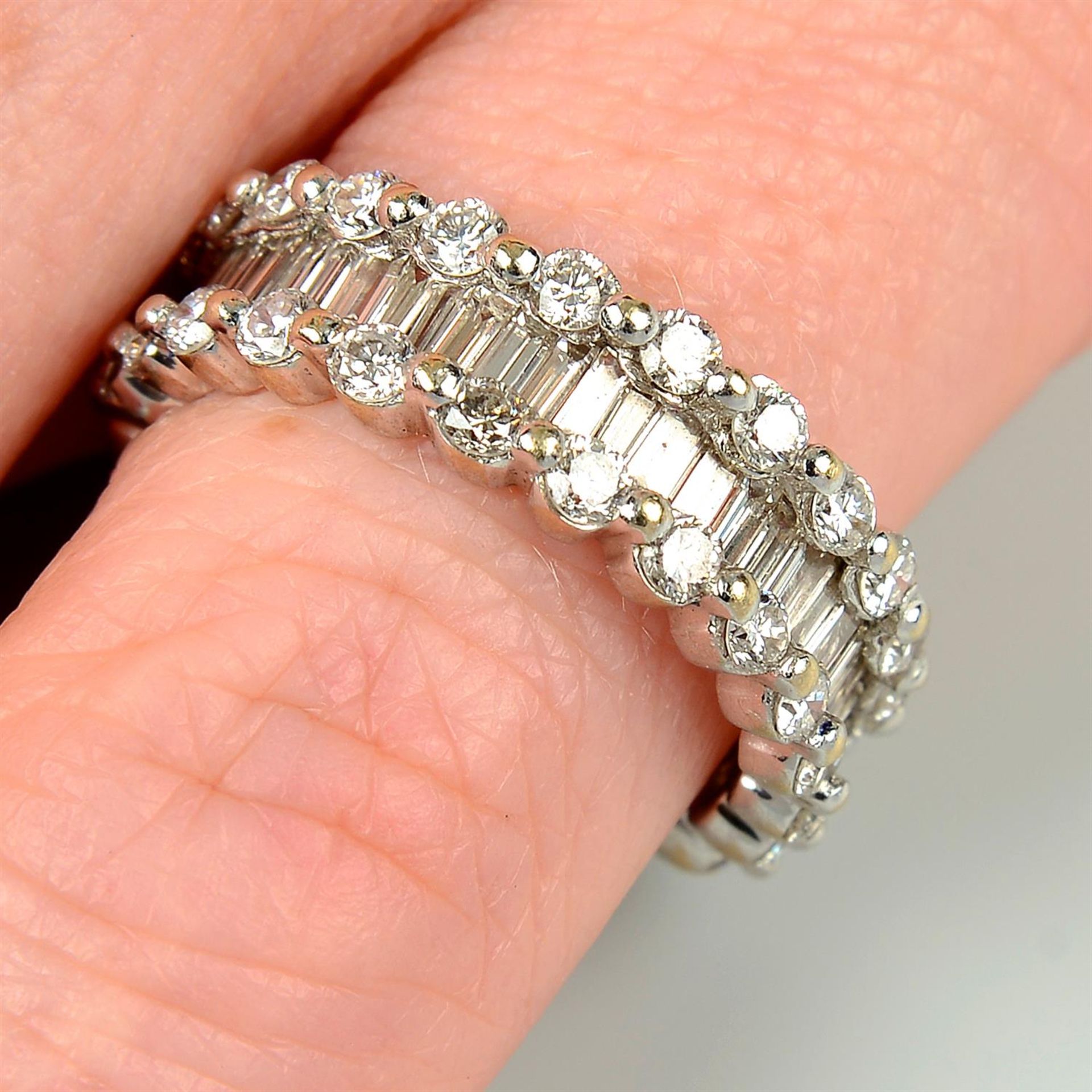 A brilliant and baguette-cut diamond full eternity ring.