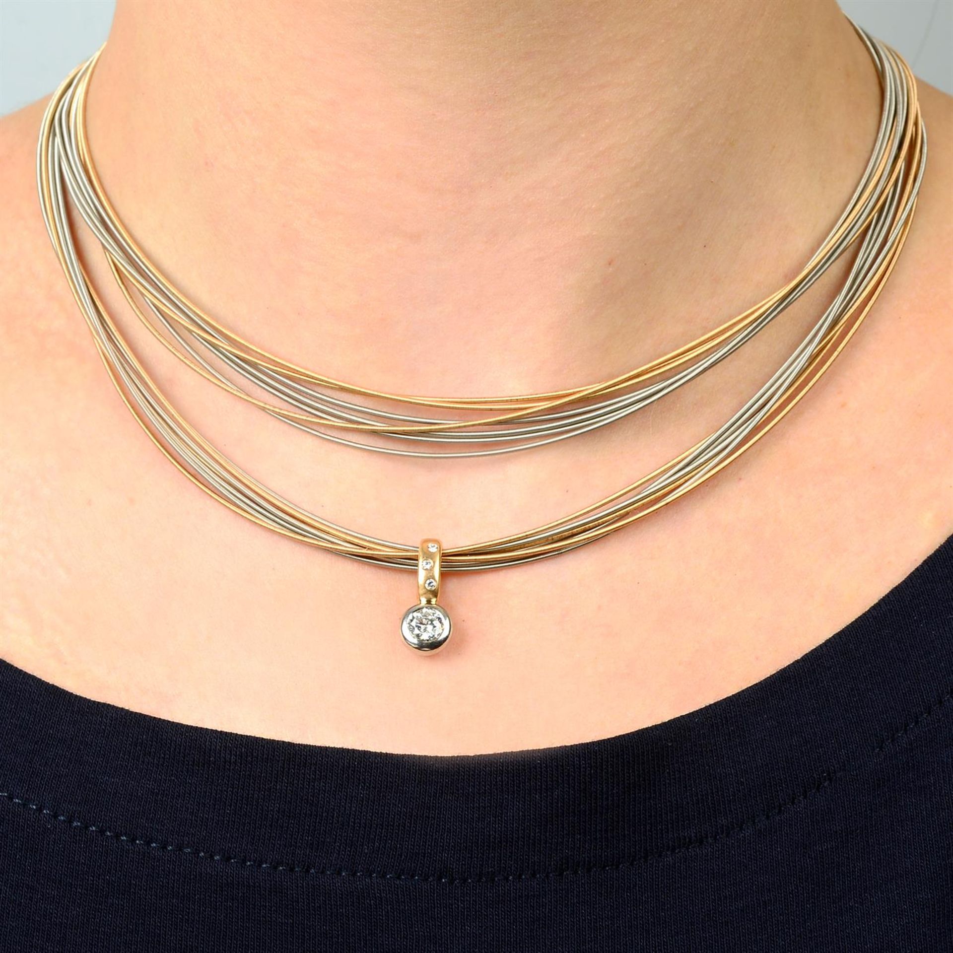 A bi-colour 18ct gold brilliant-cut diamond pendant, on multi-strand chain, by Boodles.