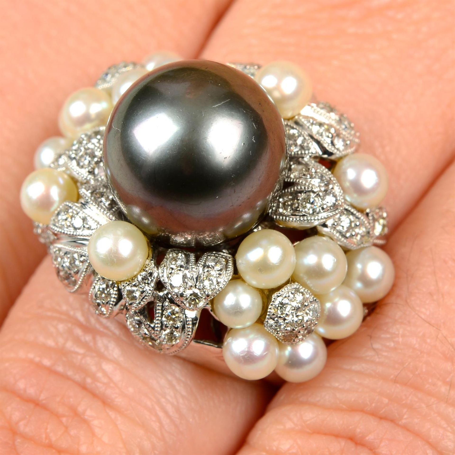 A 'Tahitian' grey cultured pearl, brilliant-cut diamond and cultured pearl floral bombé ring.
