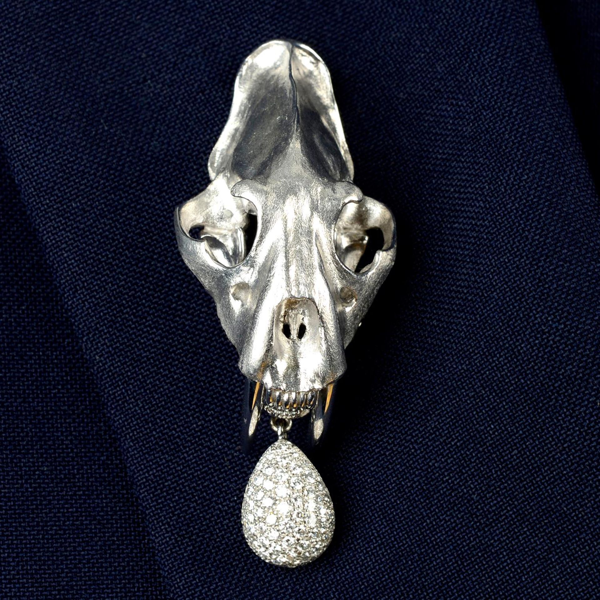 An 18ct gold animal skull brooch, with pavé-set diamond egg drop, by E. Wolfe & Co.