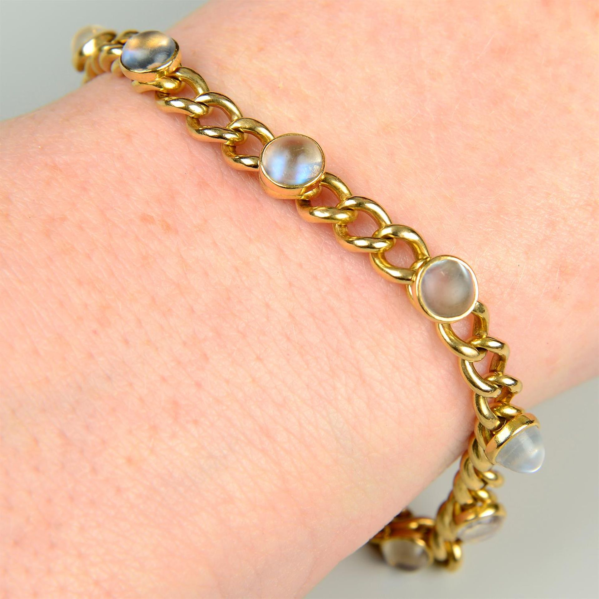 A late 19th century gold curb-link bracelet, with moonstone spacers.