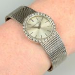 A 1970s 9ct gold wristwatch, with brilliant-cut diamond bezel, on integral bracelet,