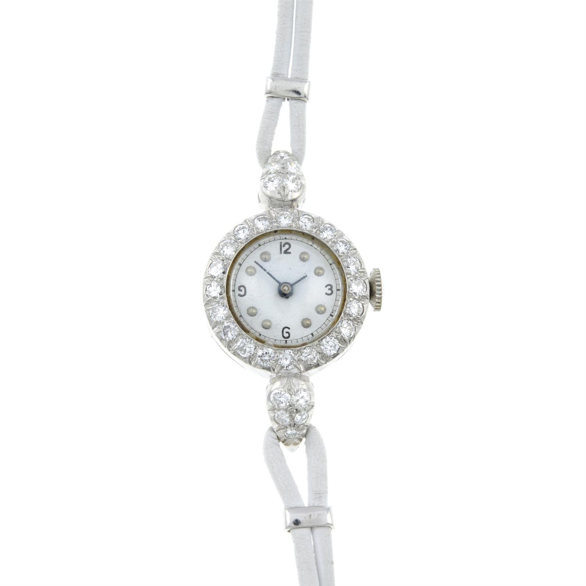 A diamond cocktail watch, with a white leather strap.