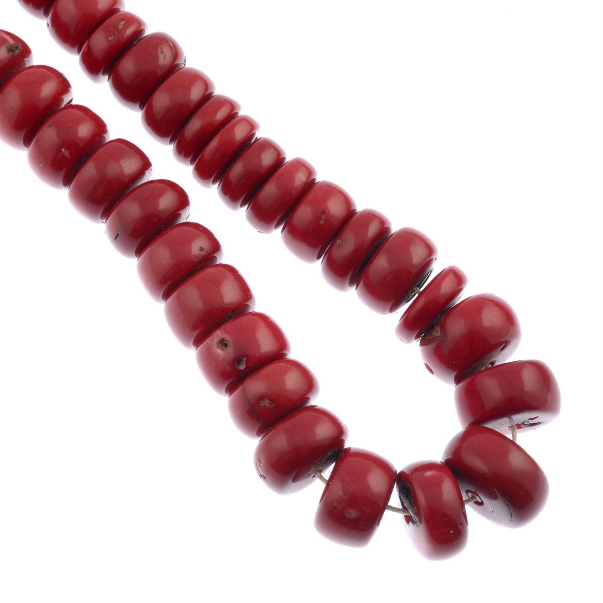 A coral single-strand necklace.