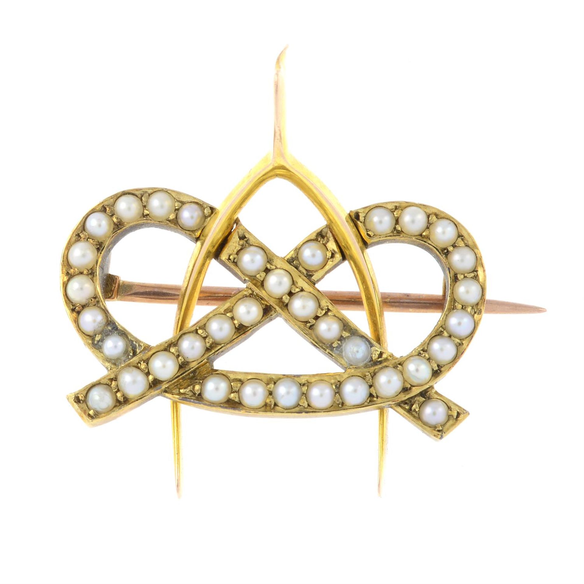 A late Victorian 15ct gold seed pearl lovers knot wishbone brooch.