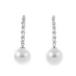 A pair of cultured pearl and diamond drop earrings.
