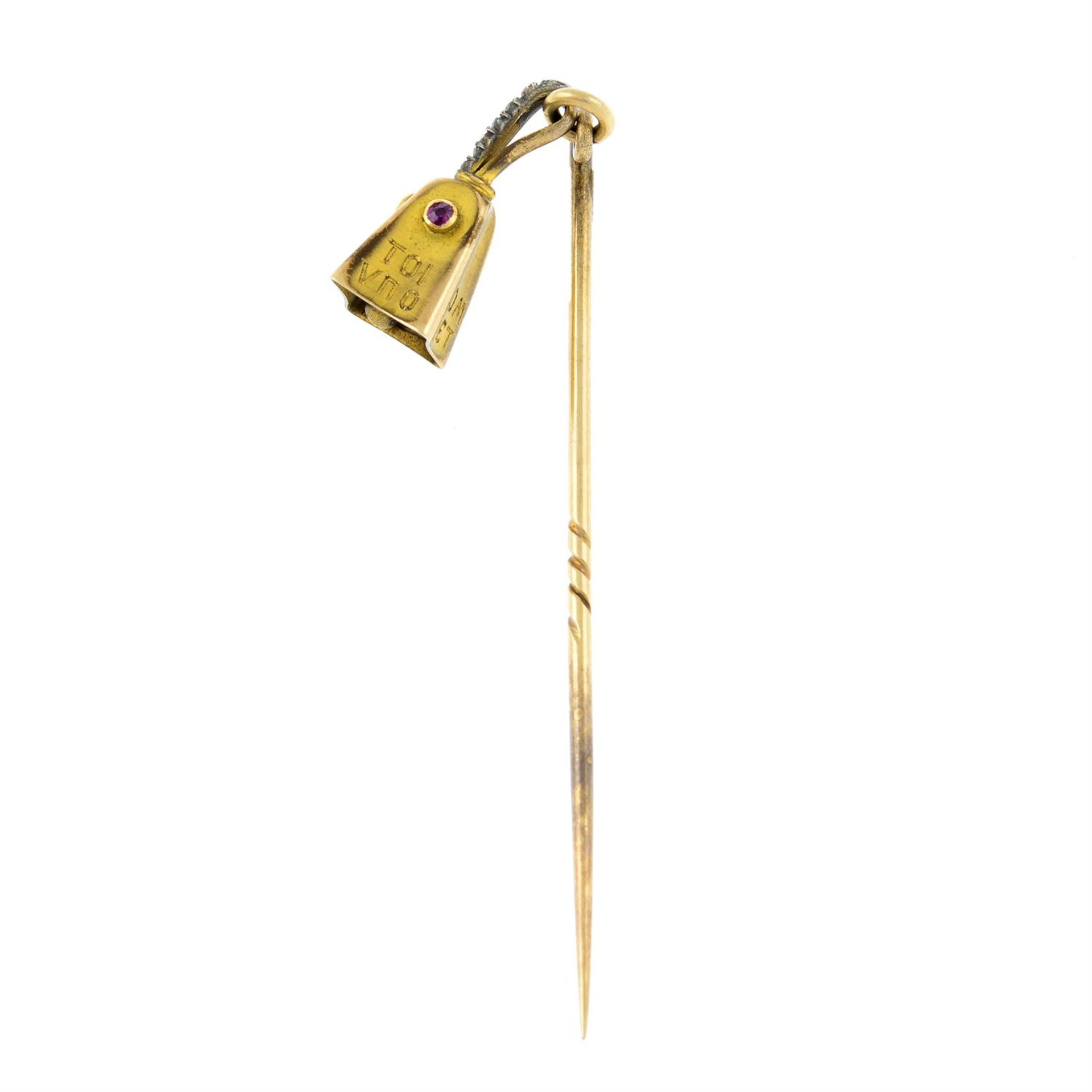An early 20th century gold ruby and rose-cut diamond bell stickpin.