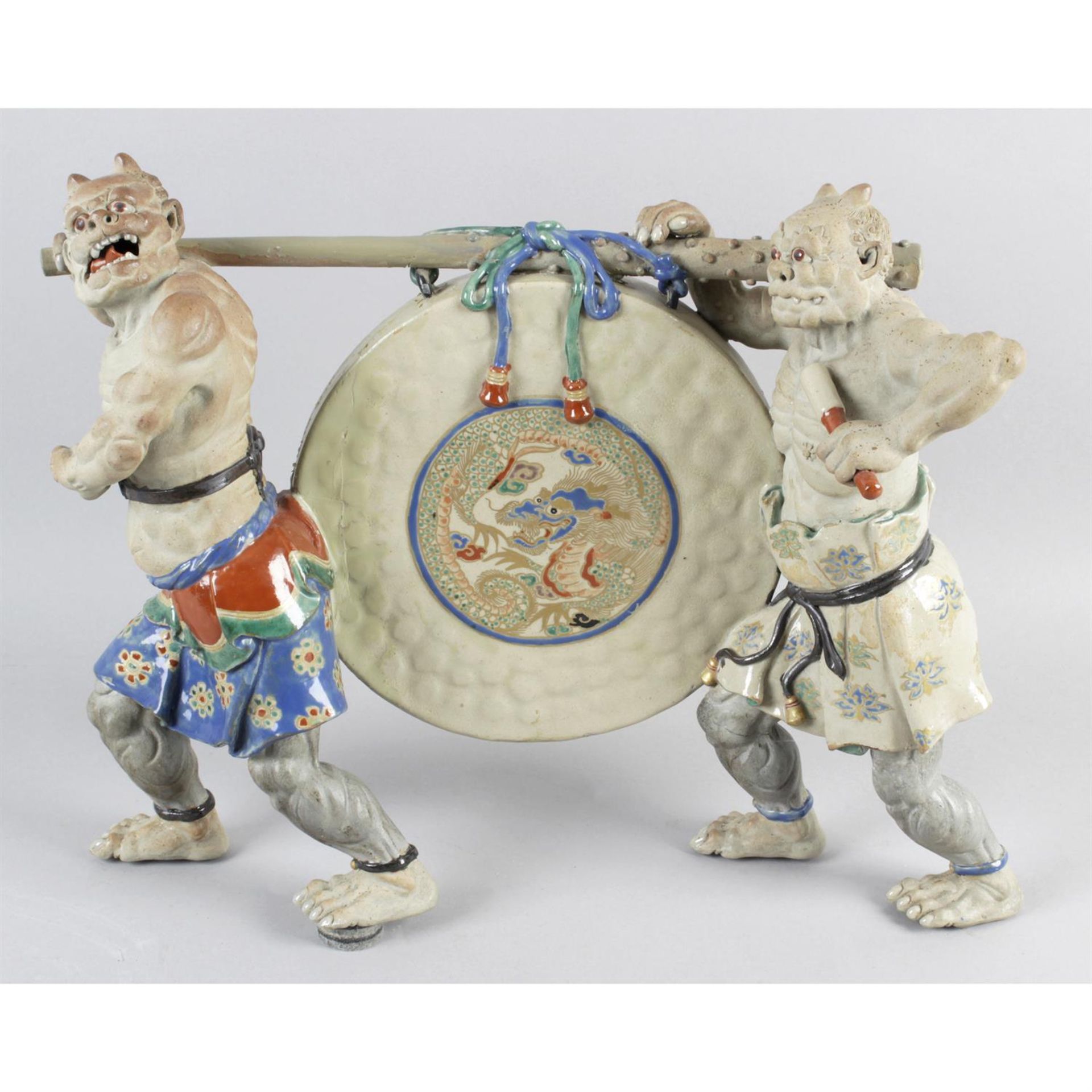 An unusual Japanese pottery figure group.