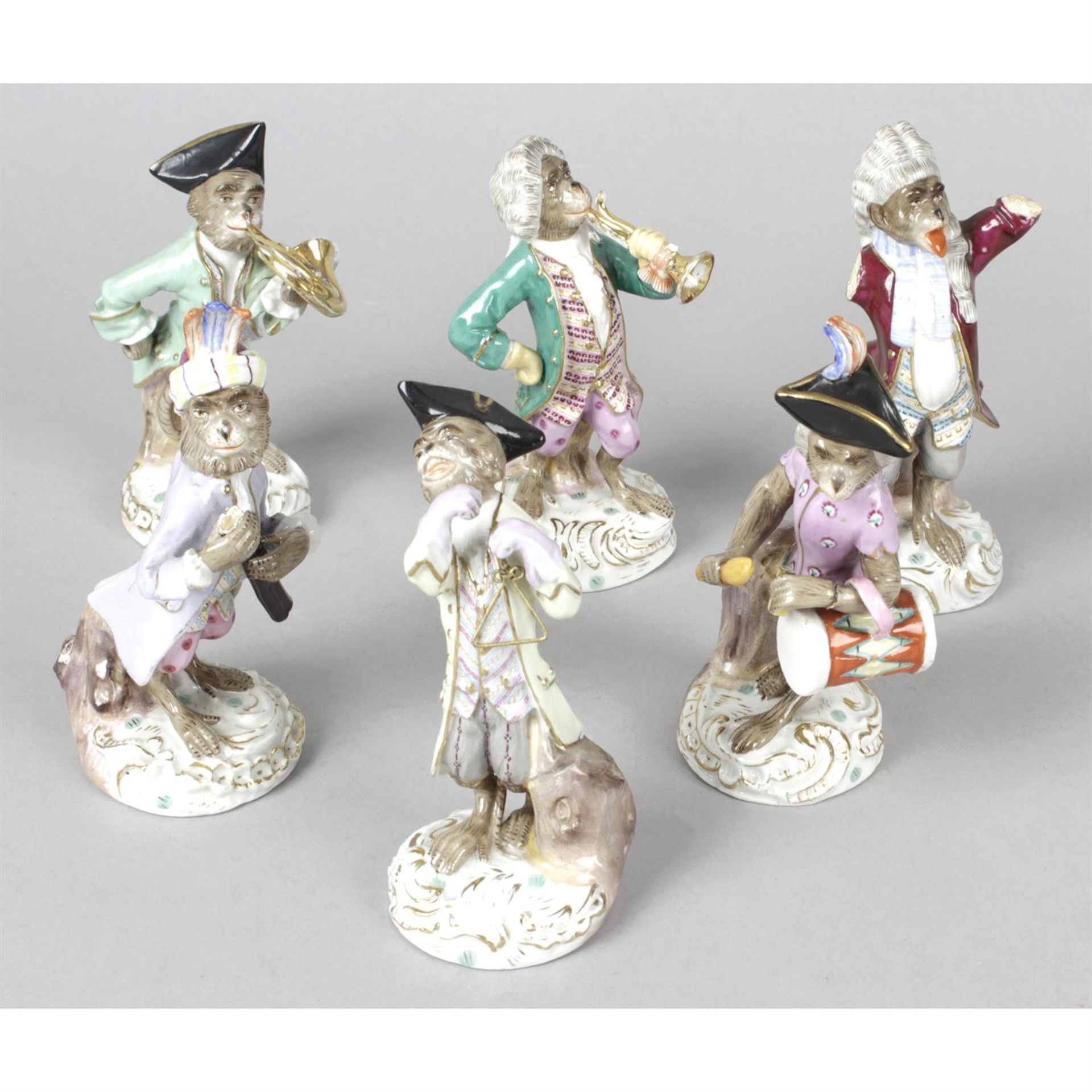 A group of six porcelain monkey band figurines with Meissen style marks.