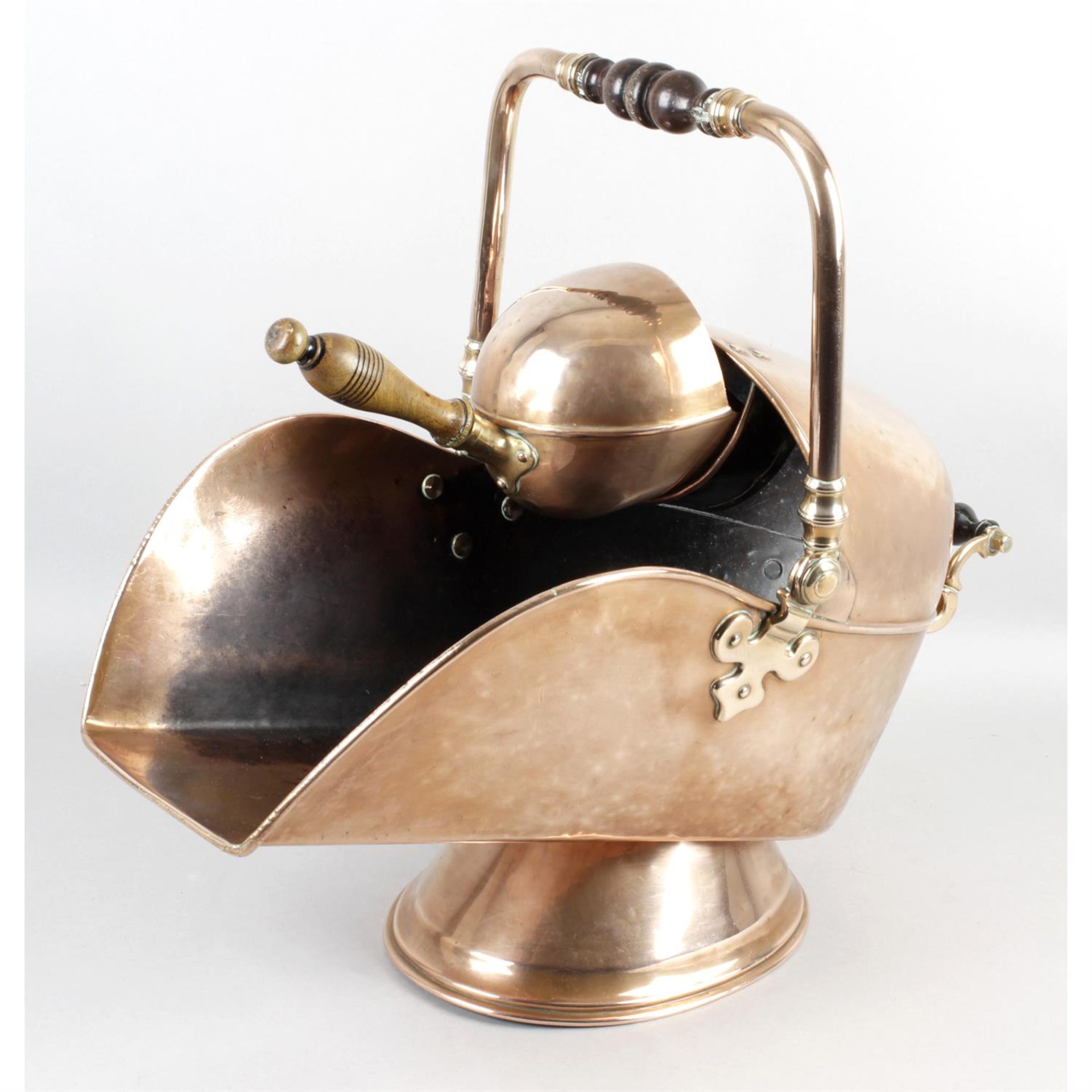 A 19th century copper coal scuttle of helmet shaped form.