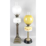 An early 20th century oil lamp, with two similar examples.