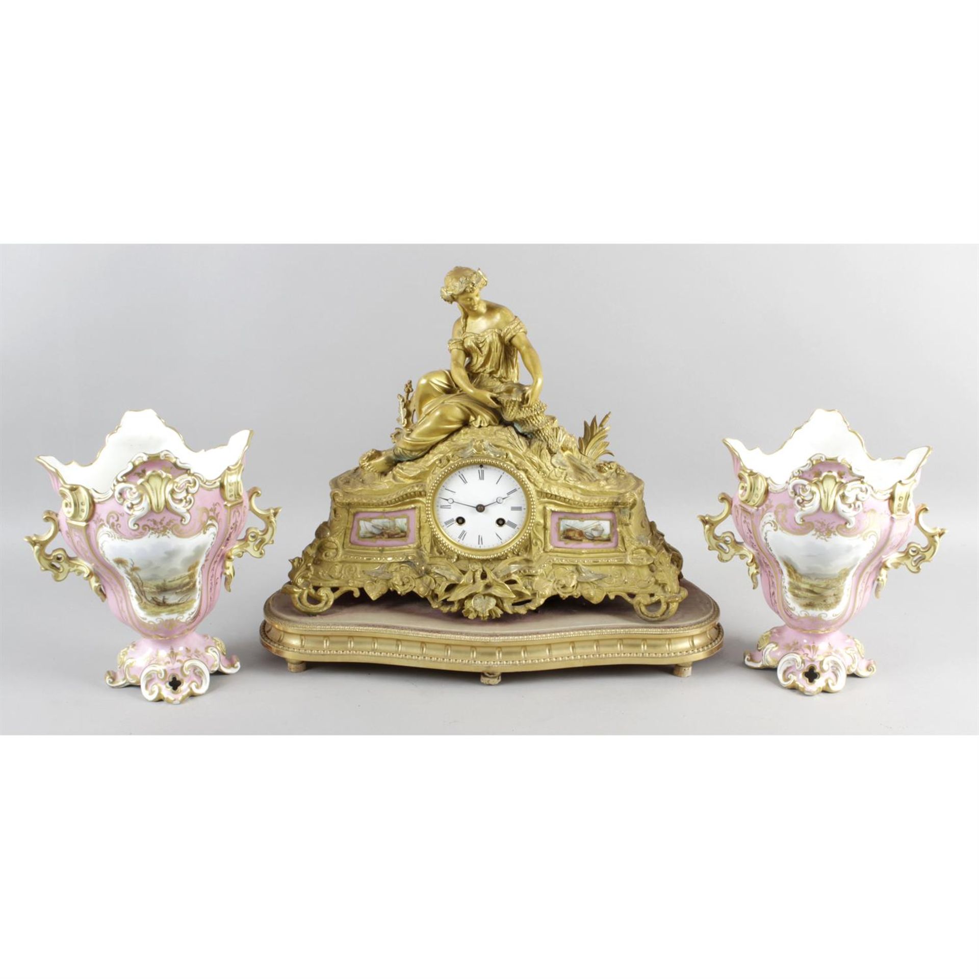 A late 19th century gilt bronze cased mantle clock, together with two porcelain vases.