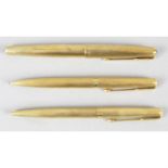An 18ct gold cased Parker pen, a similar roller ball pen and similar propelling pencil.