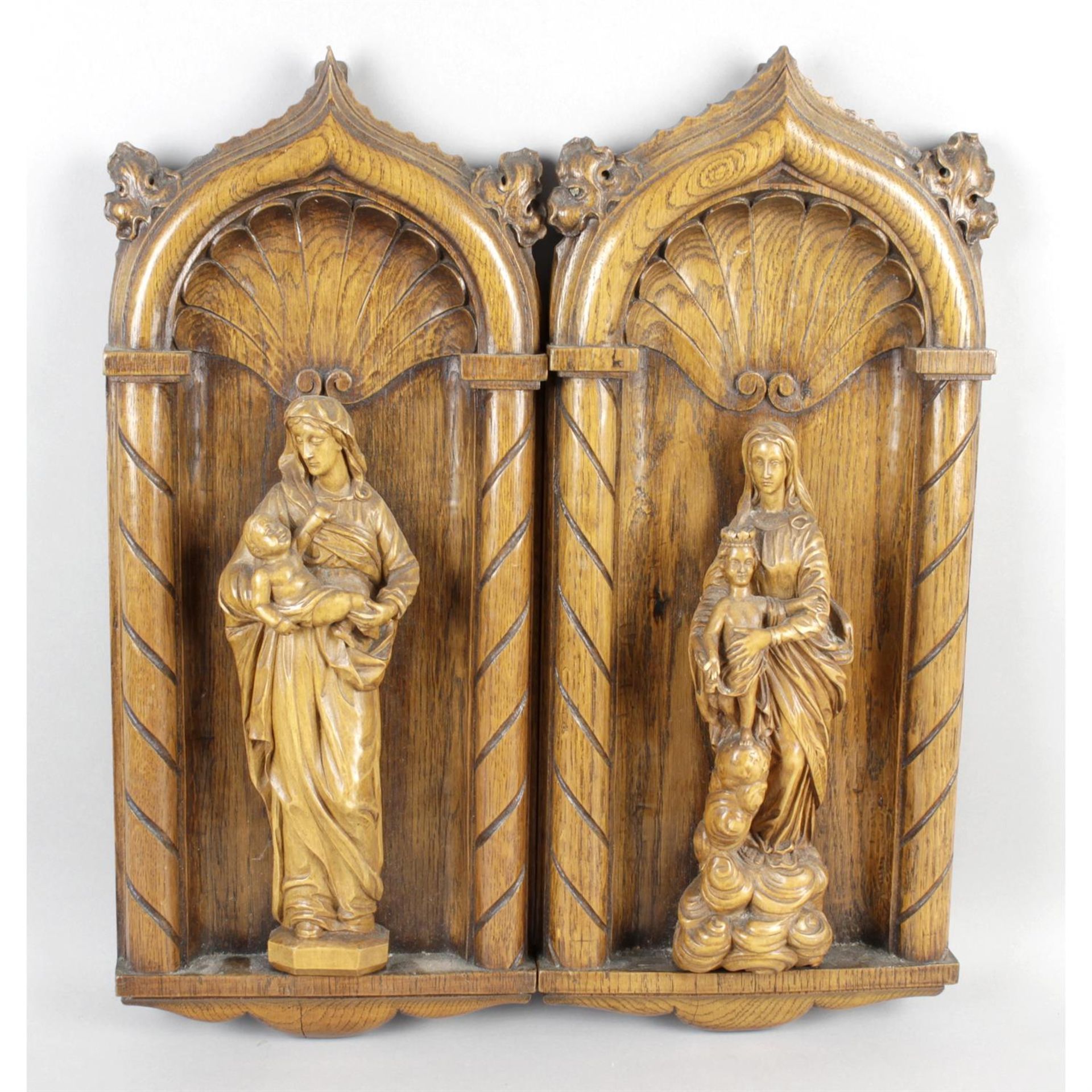 A pair of late 19th century carved oak allegorical wall plaques.
