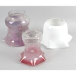 A large mixed selection of assorted glass oil lamp shades, chimney and reservoirs.