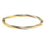 A 9ct gold tricolour hinged bangle.