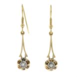 A pair of single-cut diamond drop earrings.