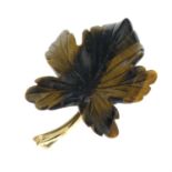 A 1970s 9ct gold carved tiger's-eye pendant, depicting a leaf.