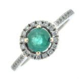 An 18ct gold emerald and diamond cluster ring, with diamond line shoulders.