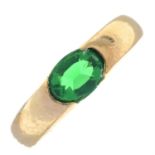 A tension-set green paste band ring.