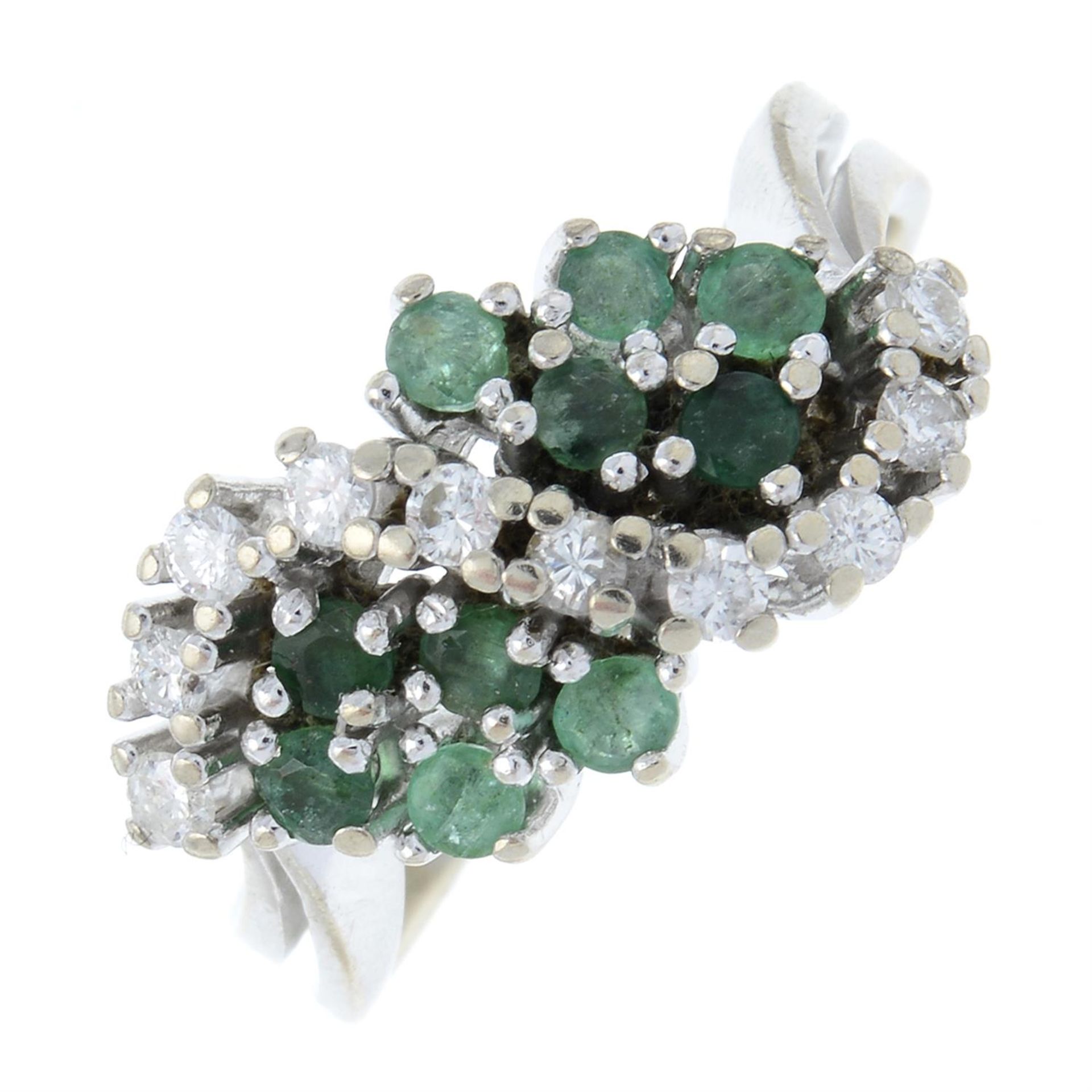 A brilliant-cut diamond and emerald cluster ring.