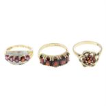 Three 9ct gold and garnet rings.