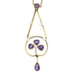 An early 20th century gold amethyst and seed pearl foliate pendant, on integral chain.