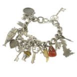 A silver charm bracelet, suspending eighteen variously designed charms.
