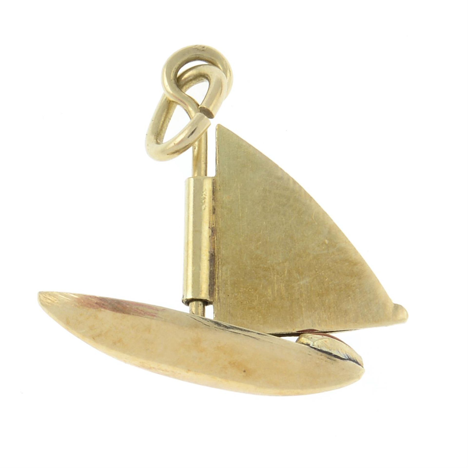 A mid 20th century gold sailing boat charm, with red enamel heart bow and white enamel sail. - Image 2 of 2
