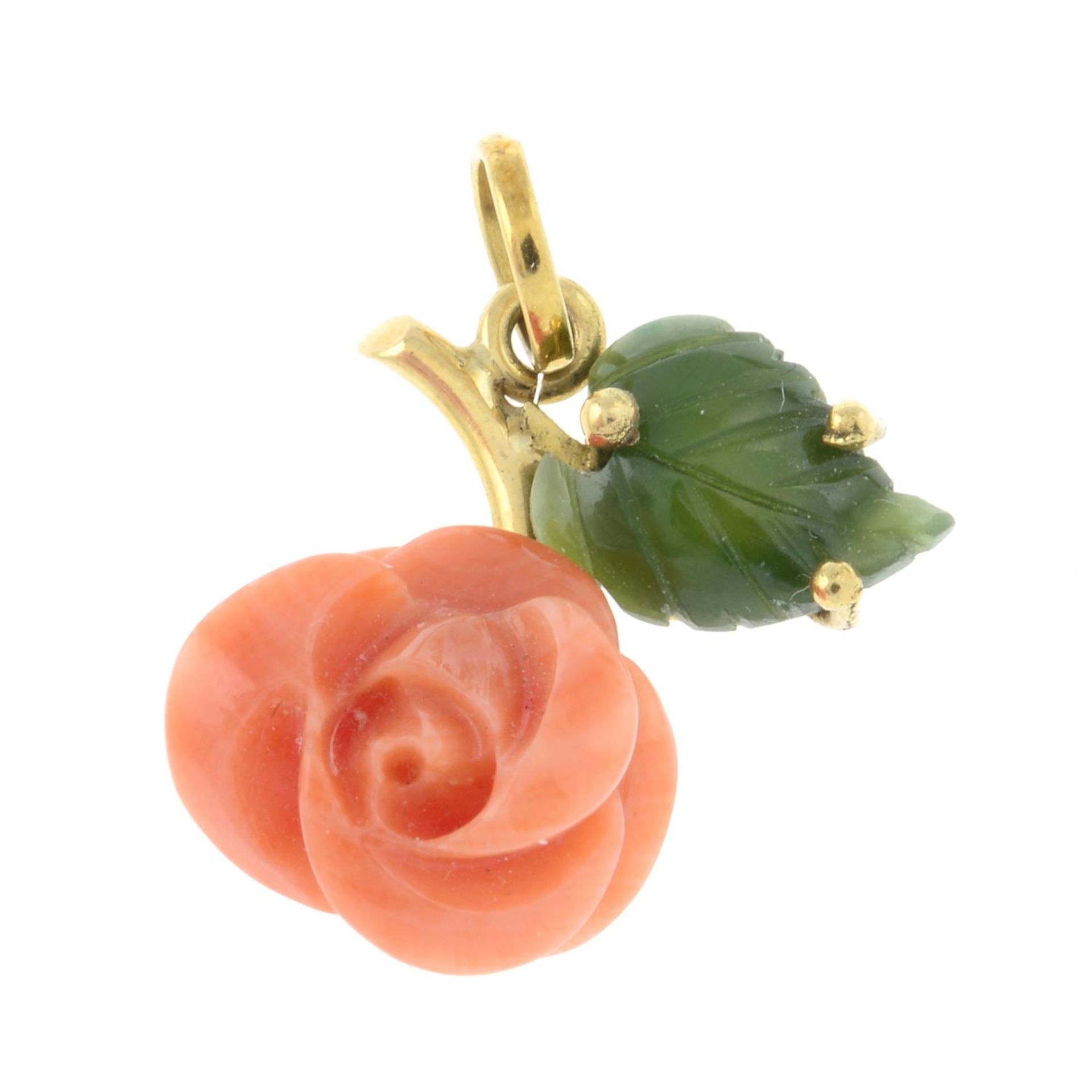 A carved coral and nephrite rose pendant.