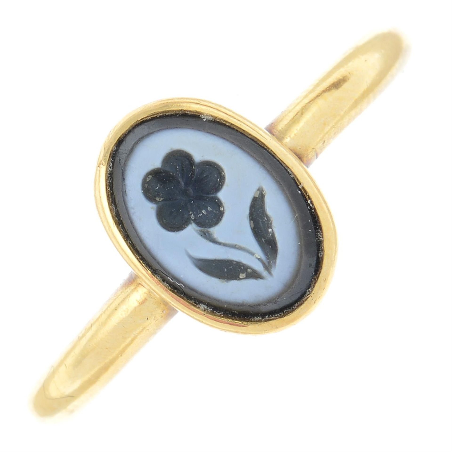 An early 20th century 18ct ring, with later 19th century gold carved banded onyx forget-me-not