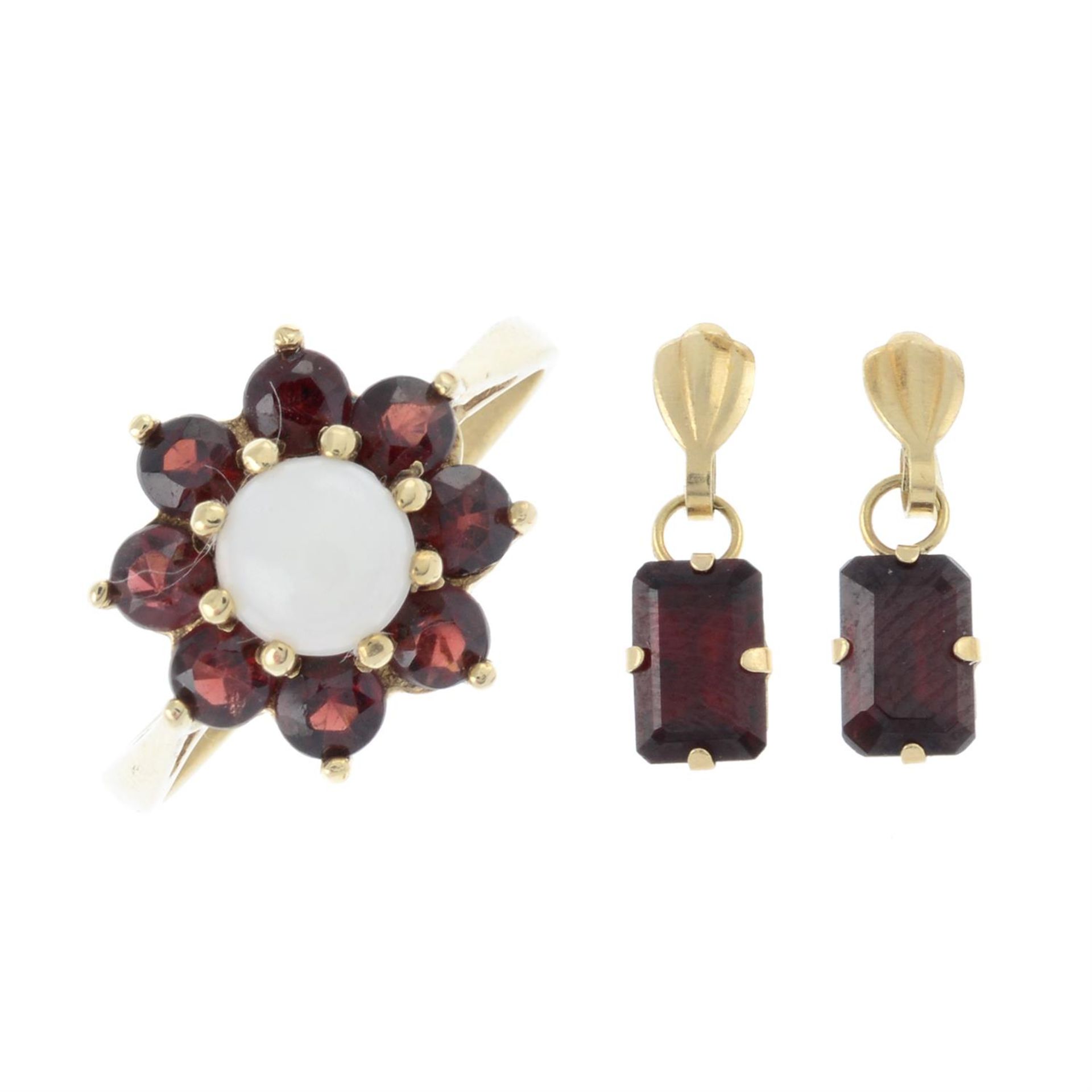 An opal cabochon and garnet cluster ring, together with a pair of garnet drop earrings.